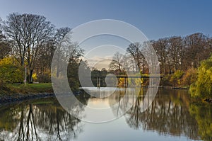 Autumn landscape with bridge over lake