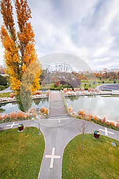 Autumn landscape of Drumul Taberei Park in Bucharest city capital of Romania with cloudy sky and great fall colors