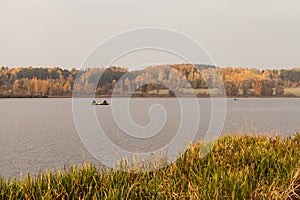 Autumn landscape with fisherman