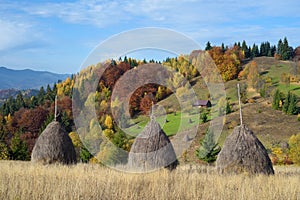 Autumn landscape with a haystacks in the mountains