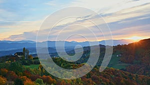 Autumn landscape with hills, Alps mountains and colorful trees in South Styria, a charming region on the border between Austria