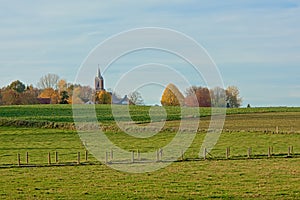 Autumn landscape with historic church in the Flemish countryside