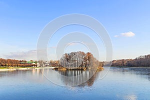 The autumn landscape. The Island on the pond. The first ice on the water