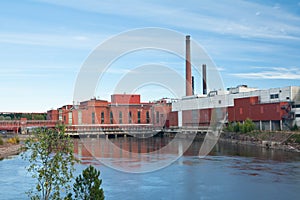 Autumn landscape of Kymijoki river waters and Myllykoski factory in Finland, Kymenlaakso, Kouvola photo