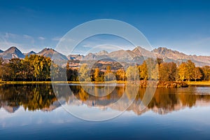 Autumn landscape, mirroring of mountains on the water surface