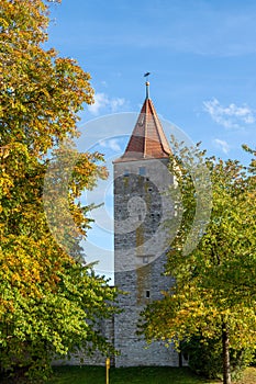 Autumn landscape with multicolored trees and city wall with tower in Berching, Bavaria