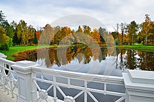 Autumn landscape with pond and white railing Large Lamsky bridge