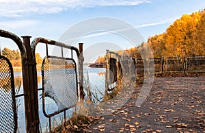 Autumn landscape river and pier with a sunken destroyed house in Chernobyl