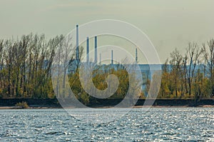 Autumn landscape,  river, windy weather, dark blue water, yellow-red autumn leaves on trees, last warm days