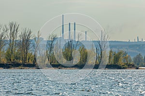 Autumn landscape,   river, windy weather, dark blue water, yellow-red autumn leaves on trees, last warm days