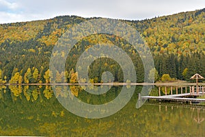 Autumn landscape. Saint Ana lake in Romania, the only volcanic lake in Europe, formed in a crater of a dead volcano