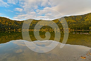 Autumn landscape. Saint Ana lake in Romania, the only volcanic lake in Europe, formed in a crater of a dead volcano