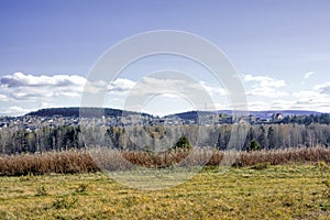 Autumn landscape sloping meadow on a background of forest and mountains