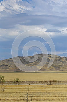 Autumn landscape, steppe with mountains. prairie, veld, veldt. a