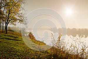 Autumn landscape, sunrise over the river and the forest, morning