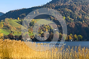 Autumn landscape with township in Upper Bavaria near mountain lake