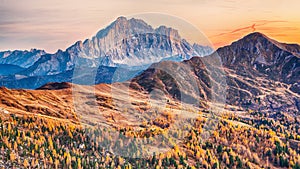 Autumn landscape with yellow larches and spectacular Monte Civetta at  sunset photo