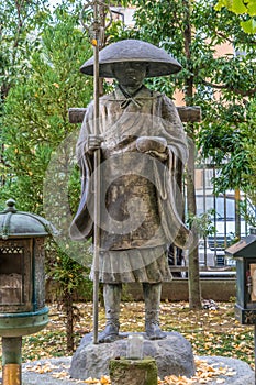 Autumn leaves around Sculpture of Kobo daishi Kukai founder of shingon Buddhism at Shoukoku-ji Buddhist temple. Devoted to Hoshi n
