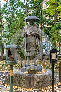 Autumn leaves around Sculpture of Kobo daishi Kukai founder of shingon Buddhism at Shoukoku-ji Buddhist temple. Devoted to Hoshi n