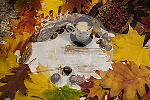 autumn leaves, chestnuts, acorns, a cup of coffee with milk