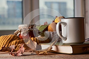 Autumn leaves, cup of coffee, warm scarf, fruits basket and book