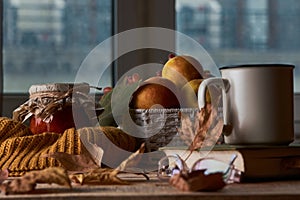 Autumn leaves, cup of coffee, warm scarf, fruits basket and book