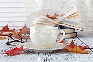 Autumn leaves and hot steaming cup of coffee