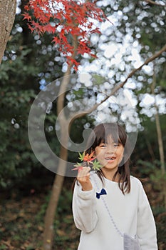 Autumn leaves and Japanese student girl