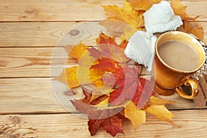 Autumn leaves in table, cup of hot coffee, autumn mood concept