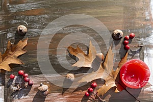 Autumn leaves on a wooden background, leaves, candles, acorns, autumn still life.