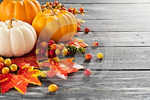 Autumn maple leaves and Pumpkin on old wooden background. photo