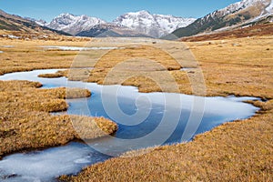 Autumn meadow with frozen river, ski resort of Baqueira Beret, S photo