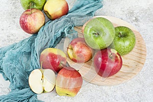 Autumn mellow apples on white stone background