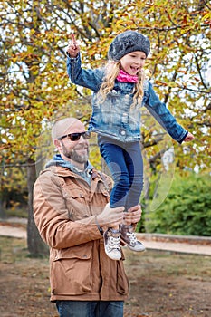 Autumn merry walk of the father and daughter