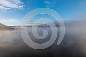 Autumn misty morning with blue sky above on Vranovska prehrada in Czech republic