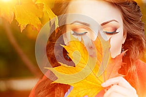 Autumn model, bright make up. woman on background fall landscape