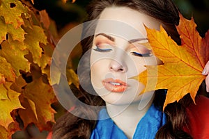 Autumn model, bright make up. woman on background fall landscape