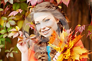Autumn model, bright make up. woman on background fall landscape