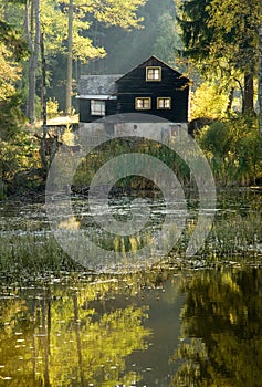 Autumn mood with hut on a lake