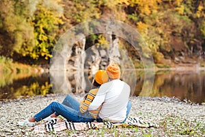 Autumn mood, vacation. Couple in love enjoying autumn. Fashionable couple on a walk in nature