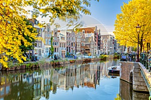 Autumn morning in Amsterdam. Silence. Ancient houses are reflected in the water of the canal, the sun shines through the trees.