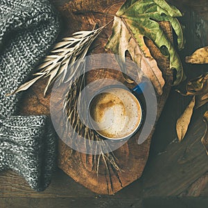 Autumn morning coffee concept with leaves and sweater, square crop