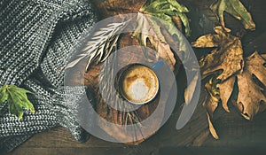 Autumn morning coffee concept with leaves and woolen sweater