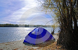 Autumn morning landscape, tent on the river bank