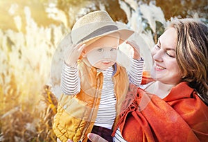 Autumn. Mother and lbaby boy (child, kid) having fun outdoors on the fall city park.