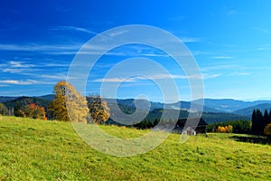 Autumn mountain landscape with blue sky