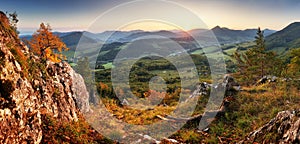 Autumn mountain panorama landcape with forest at sunset photo