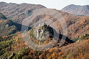 Autumn mountain scenery of Sulovske skaly in Slovakia with hills covered by colorful forest and rocks