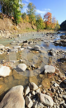 Autumn mountain stony river