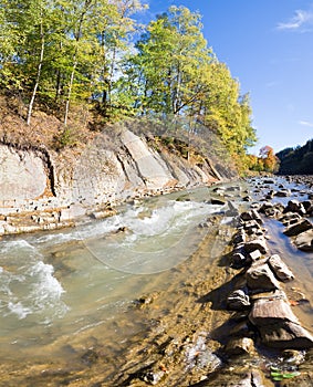 Autumn mountain stony river